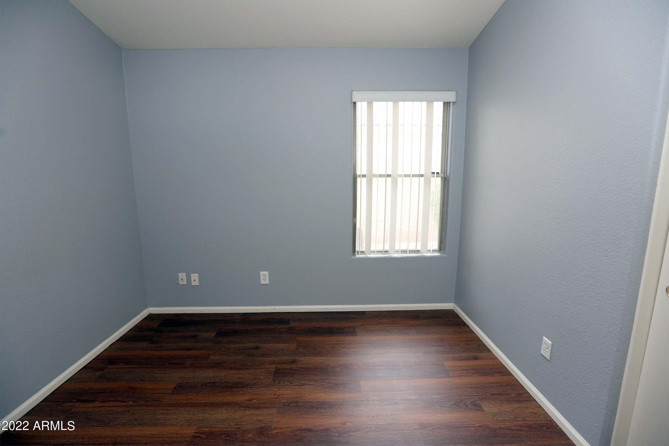 11217 West Edgemont Avenue Avondale, AZ 85392 - Photo 20 of 47 wooden floor in an empty room with a window