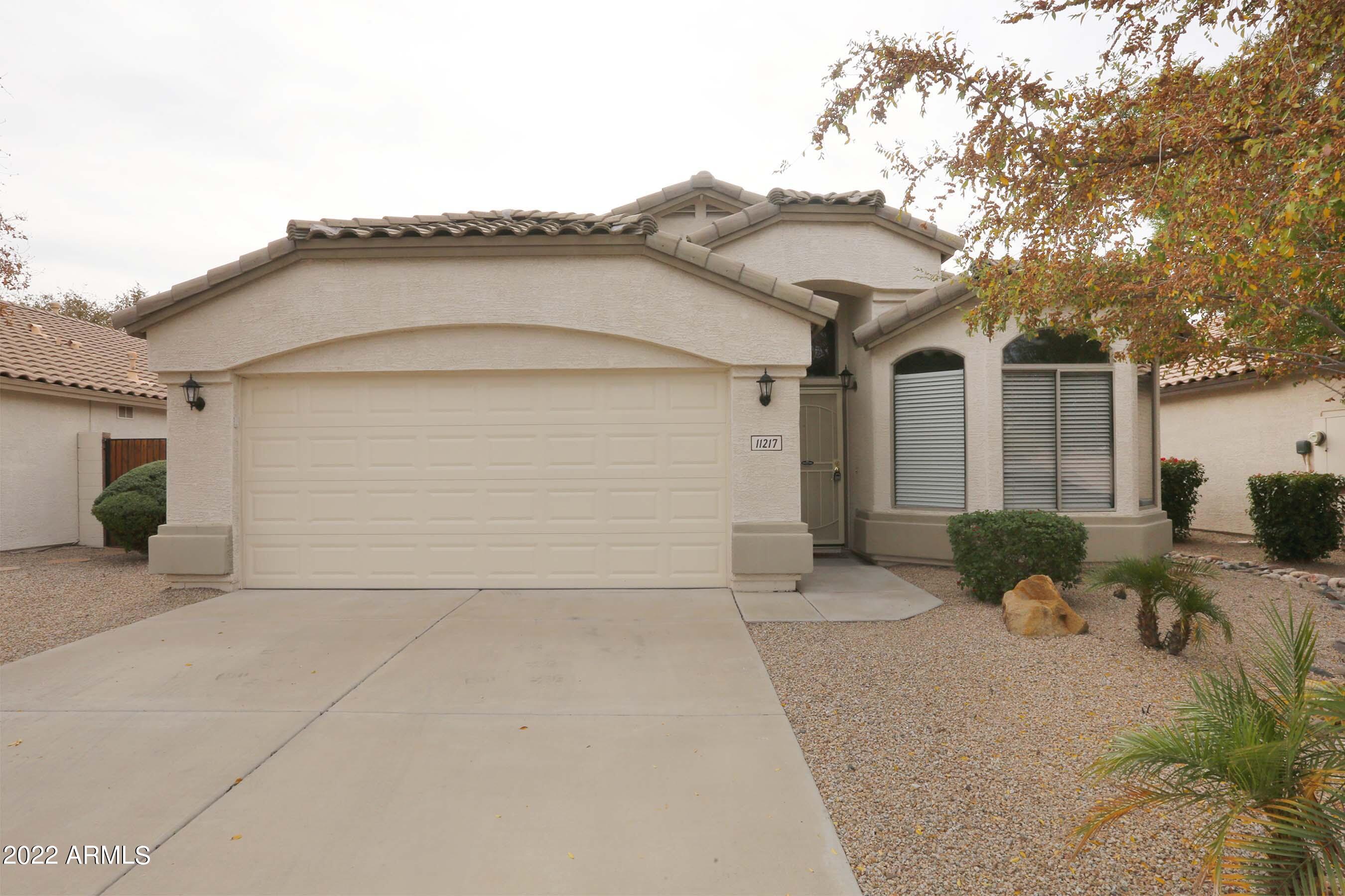 11217 West Edgemont Avenue Avondale, AZ 85392 - Photo 2 of 47 a front view of a house with a yard and garage