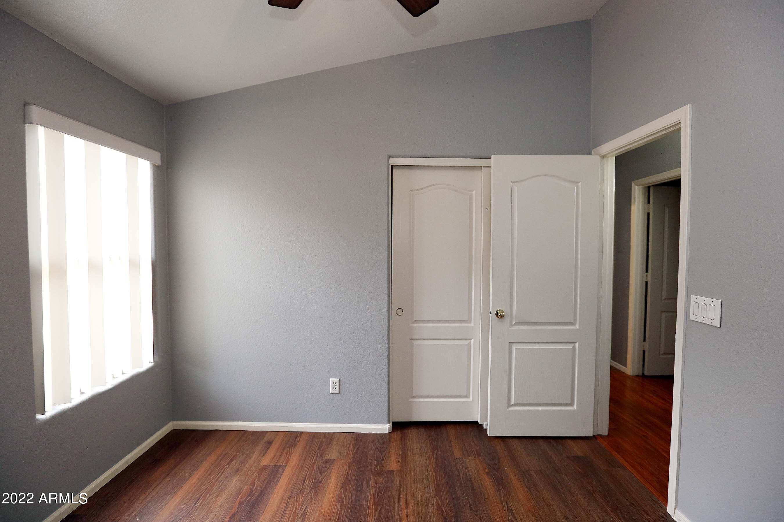 11217 West Edgemont Avenue Avondale, AZ 85392 - Photo 21 of 47 an empty room with wooden floor and windows