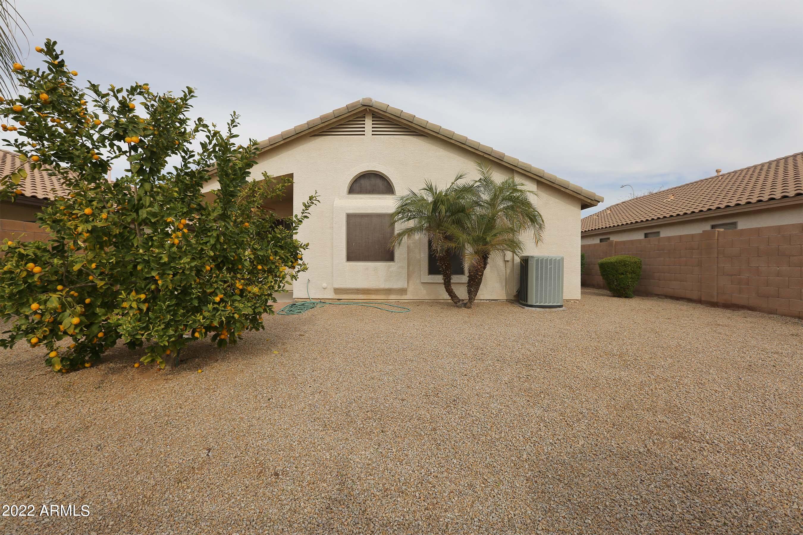 11217 West Edgemont Avenue Avondale, AZ 85392 - Photo 43 of 47 a view of a house with a yard and garage