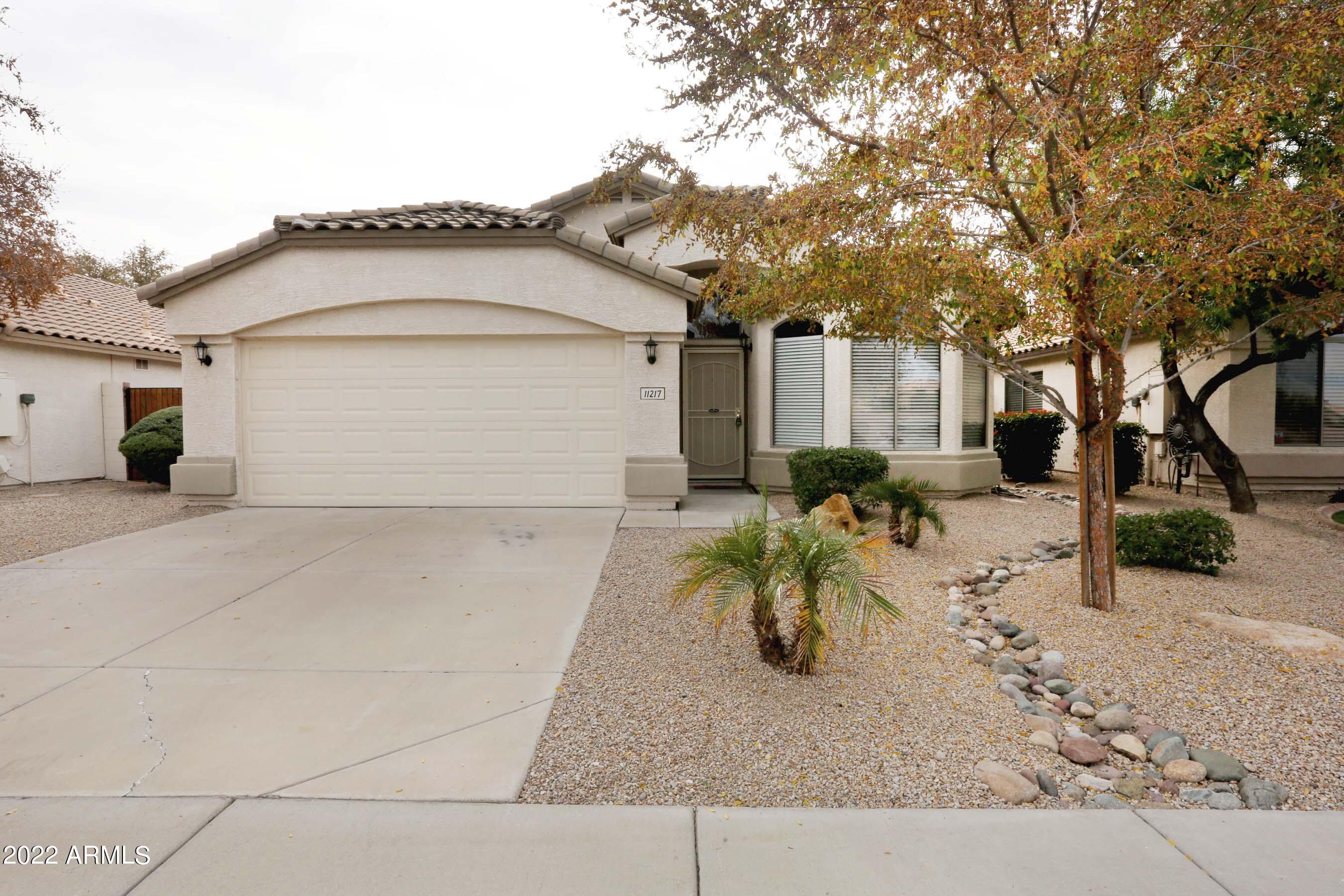 11217 West Edgemont Avenue Avondale, AZ 85392 - Photo 5 of 47 a view of a white house with a outdoor space