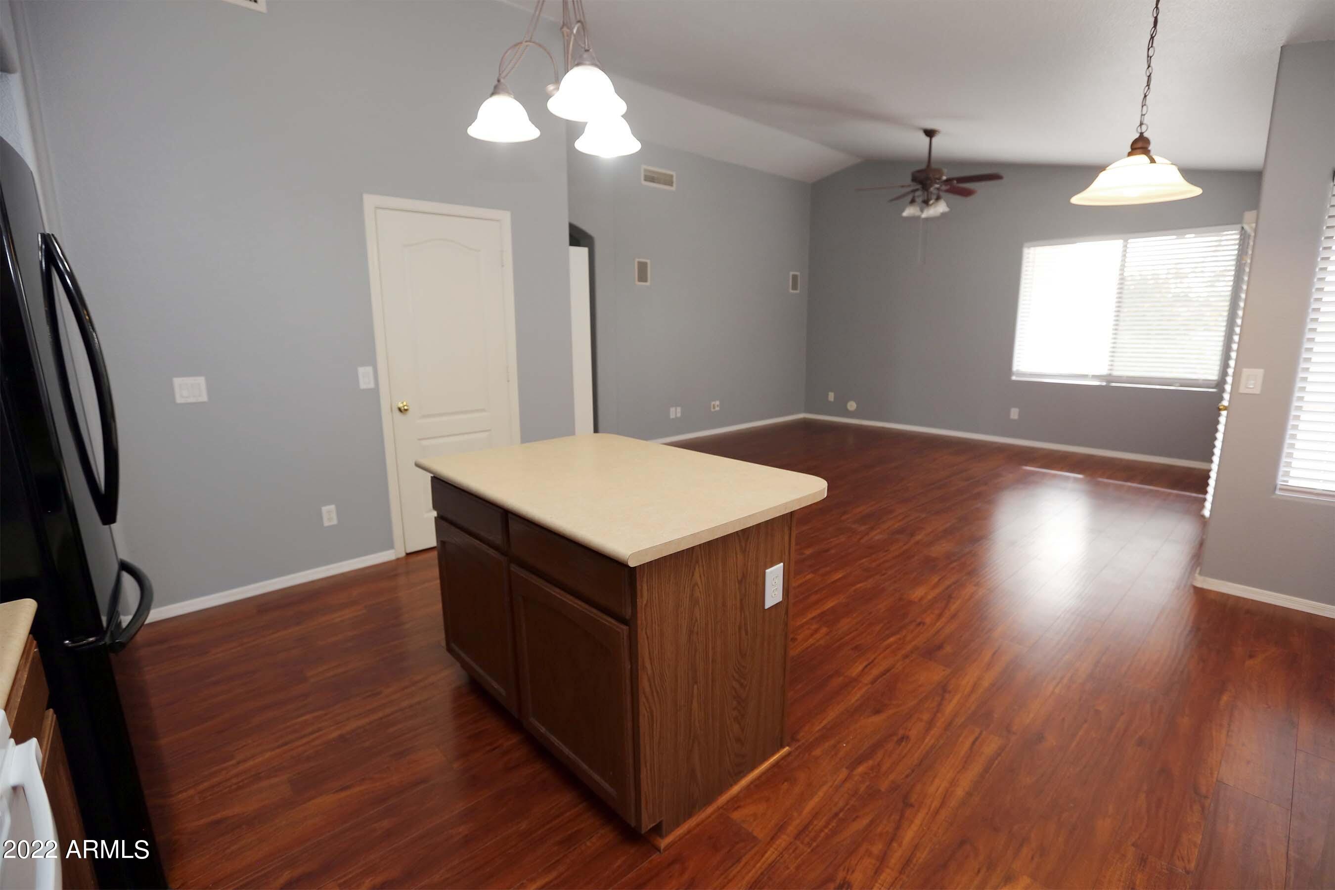 11217 West Edgemont Avenue Avondale, AZ 85392 - Photo 9 of 47 wooden floor in an empty room with a window