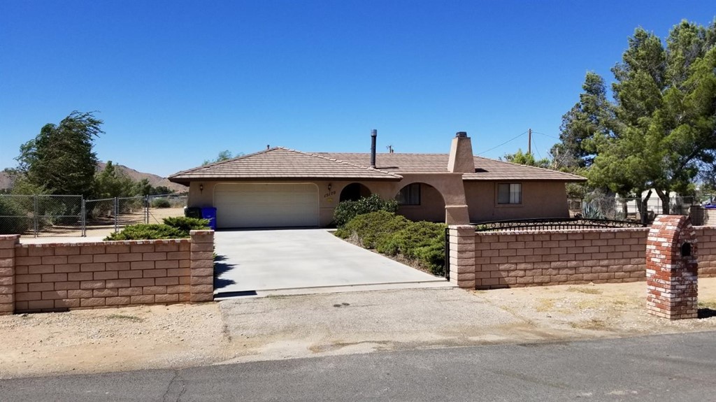 15170 Apache Road Apple Valley, CA 92307 - Photo 1 of 1 a front view of a house with a garage