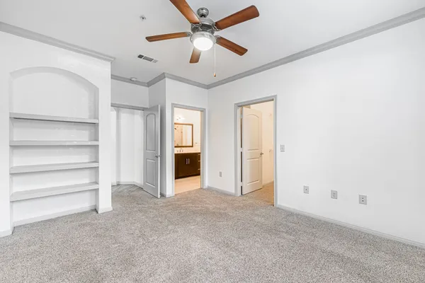 a view of an empty room with a ceiling fan