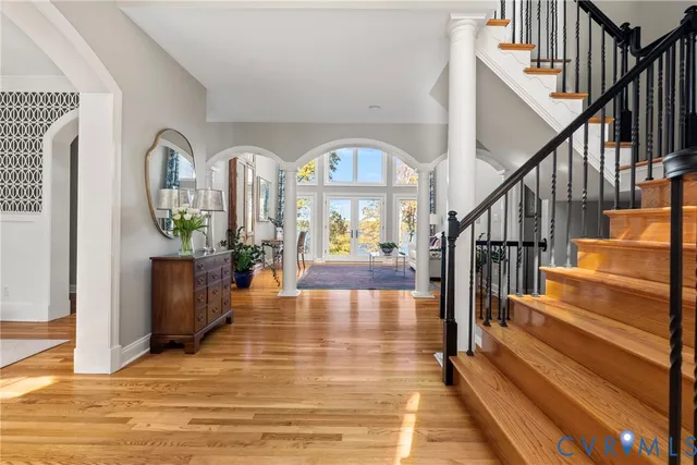 a view of entryway and hall with wooden floor