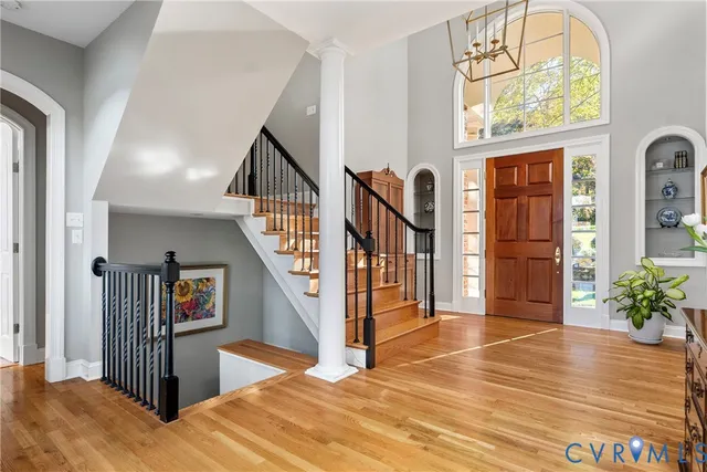 a view of a hallway with wooden floor windows and entryway