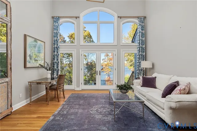 a living room with furniture a window and potted plants