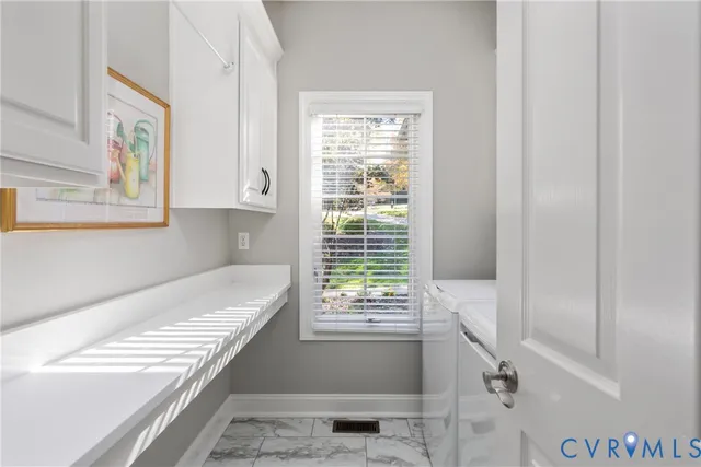 a bathroom with a bathtub and next to a window