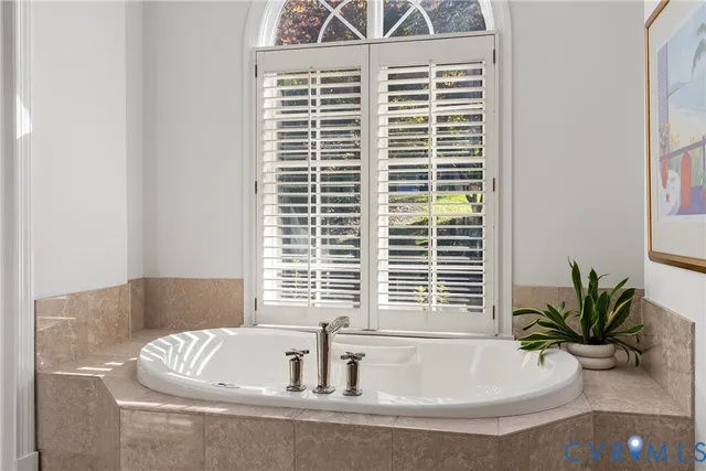 a bedroom with a bed dresser and a window