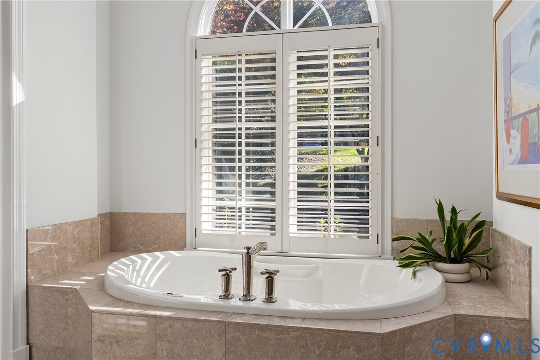 5304 Beechwood Point Court Midlothian, VA 23112 - Photo 33 of 50 a bath tub sitting in a bathroom next to a window