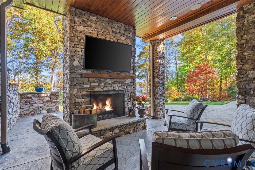5304 Beechwood Point Court Midlothian, VA 23112 - Photo 47 of 50 a living room with furniture a flat screen tv and a fireplace