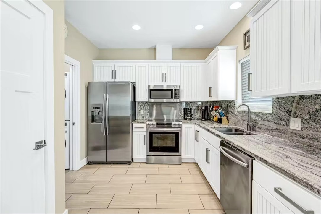 14307 Kemps Way Corpus Christi, TX 78418 - Photo 7 of 23 a kitchen with stainless steel appliances granite countertop a refrigerator sink and cabinets