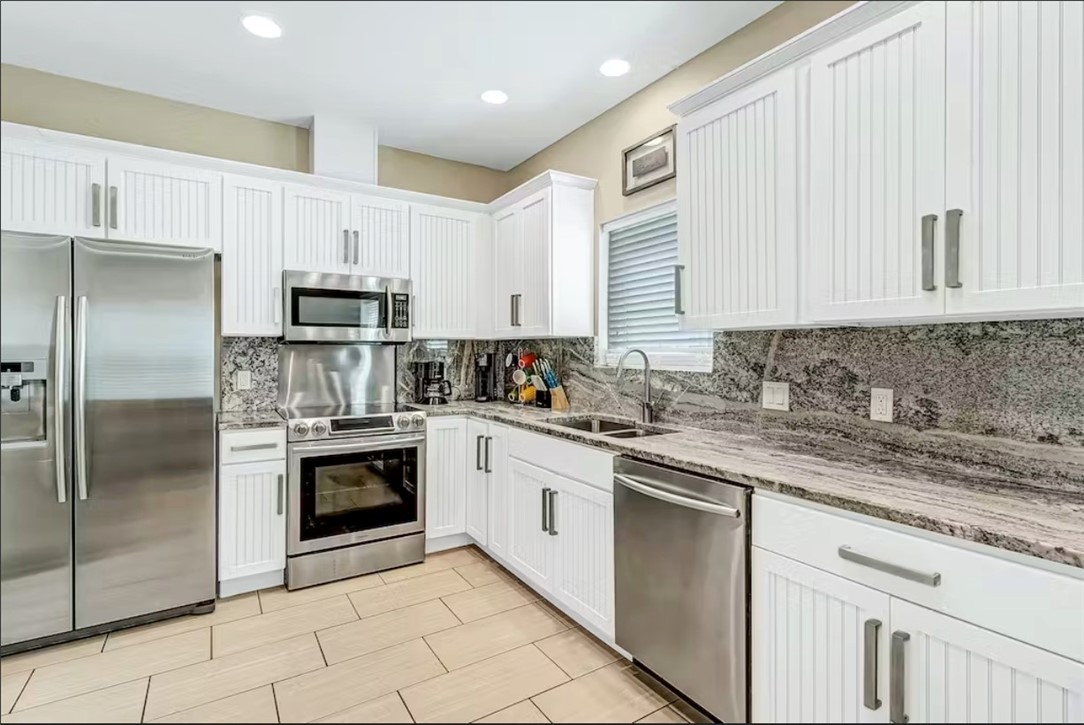 14307 Kemps Way Corpus Christi, TX 78418 - Photo 8 of 23 a kitchen with cabinets stainless steel appliances a sink and a counter space