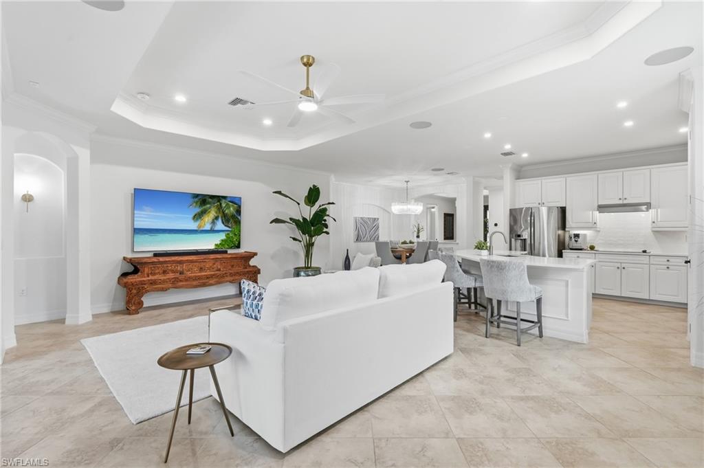 9479 Piacere Way Naples, FL 34113 - Photo 7 of 48 Open-concept living area with tray ceilings and recessed lighting