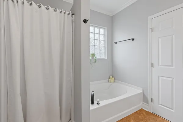 a white bath tub sitting under a bathroom