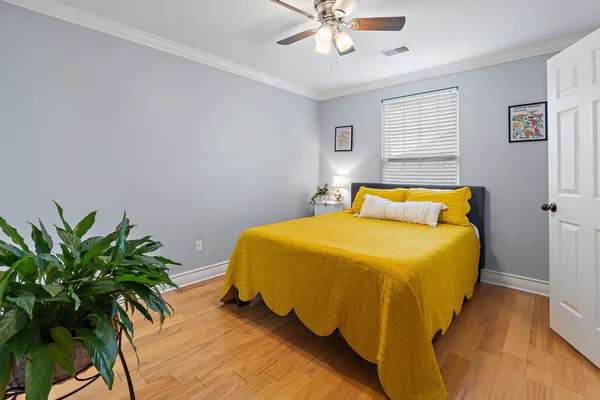 a bedroom with a bed and a potted plant