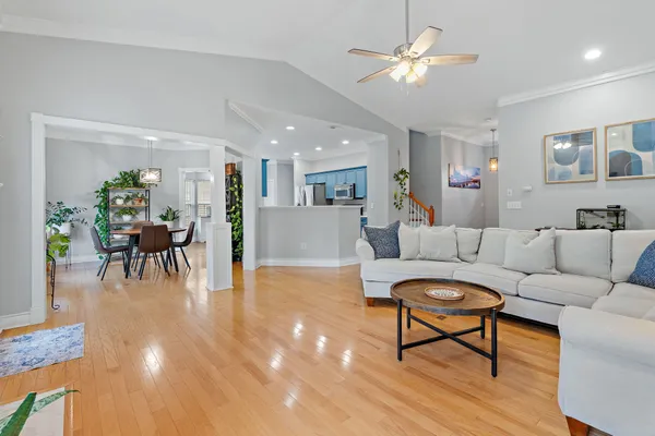 a living room with furniture and kitchen view