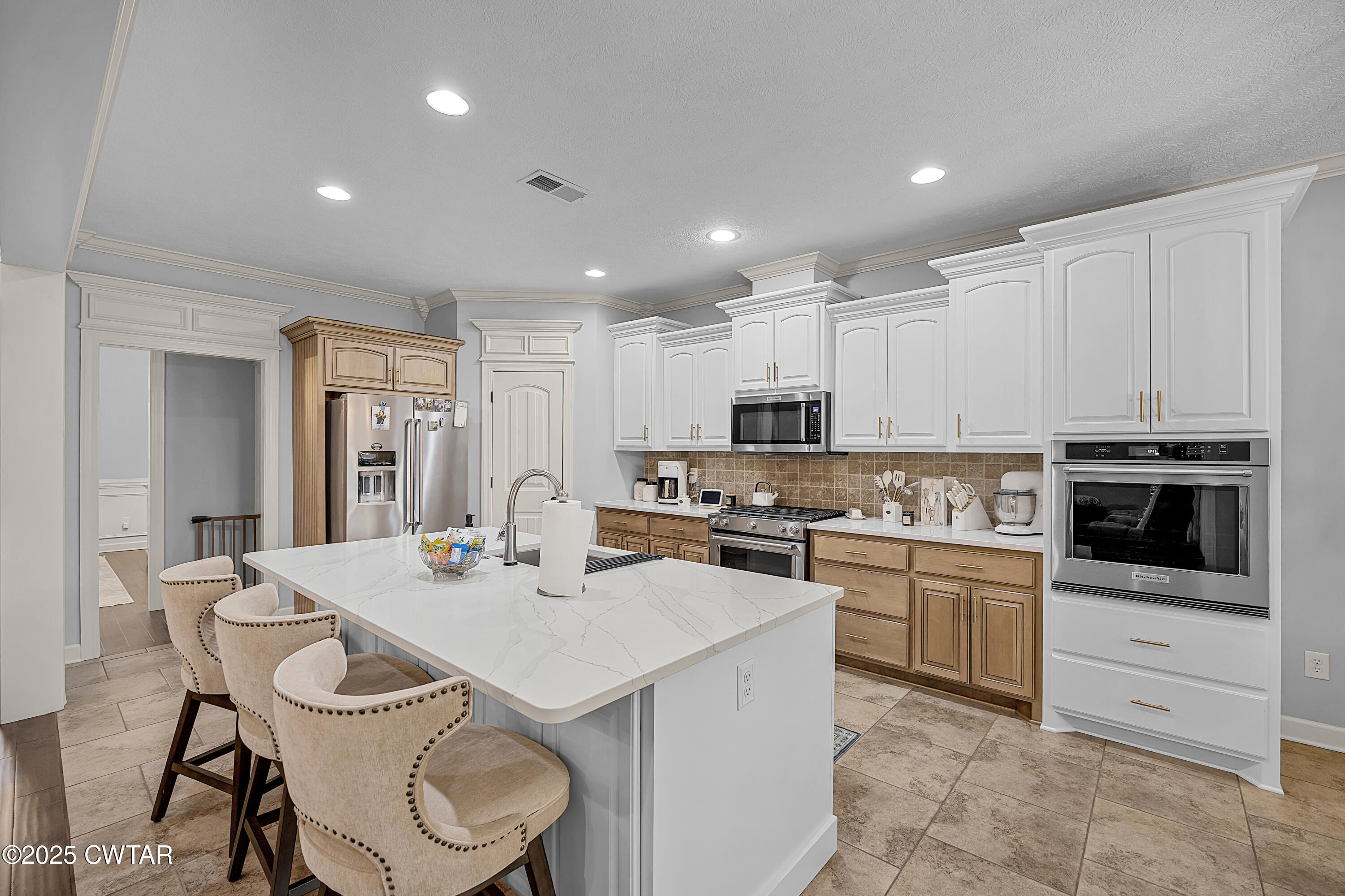 31 Perrington Cove Jackson, TN 38305 - Photo 11 of 27 a kitchen with a sink a stove and chairs