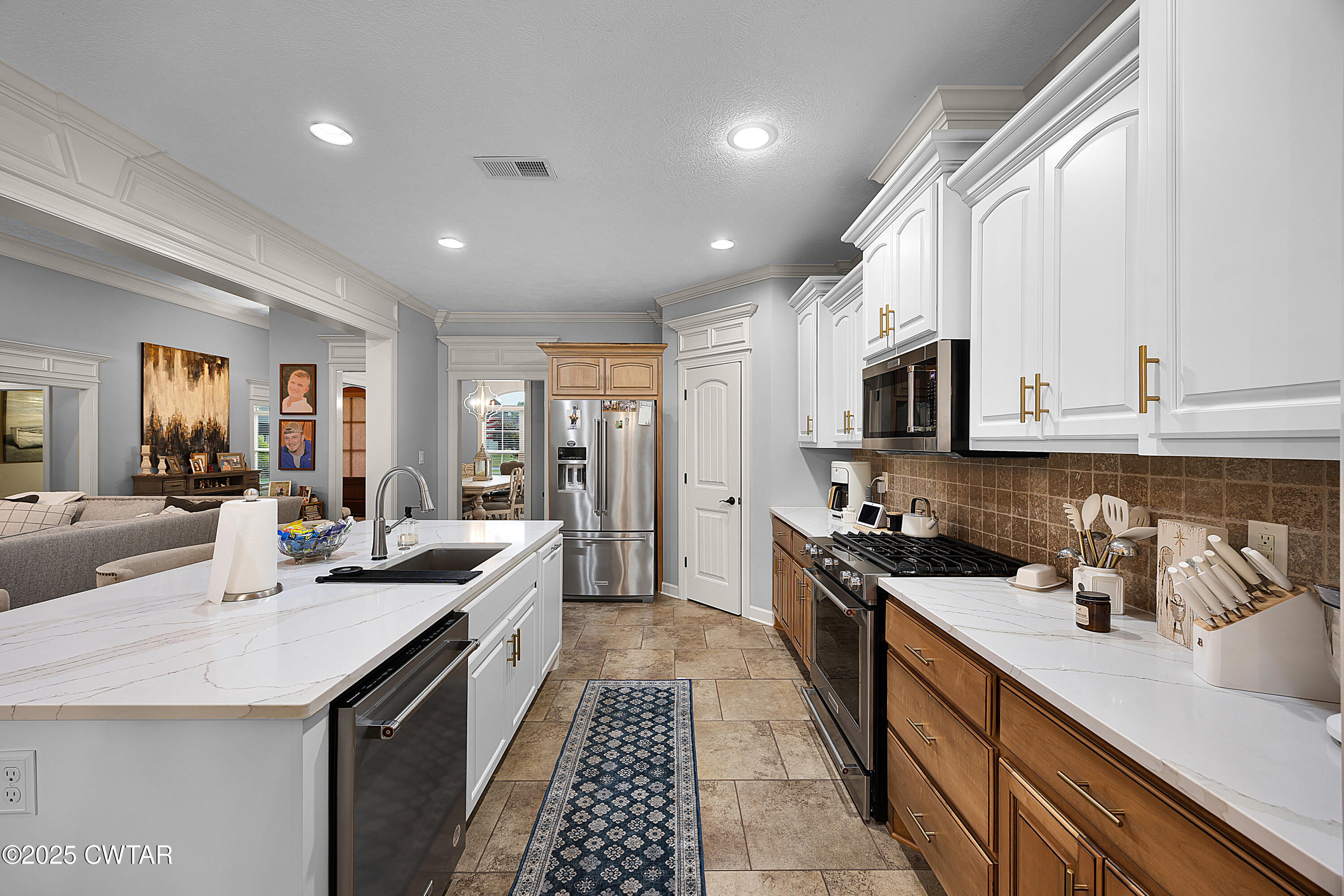 31 Perrington Cove Jackson, TN 38305 - Photo 12 of 27 a kitchen with stainless steel appliances kitchen island granite countertop a sink and cabinets