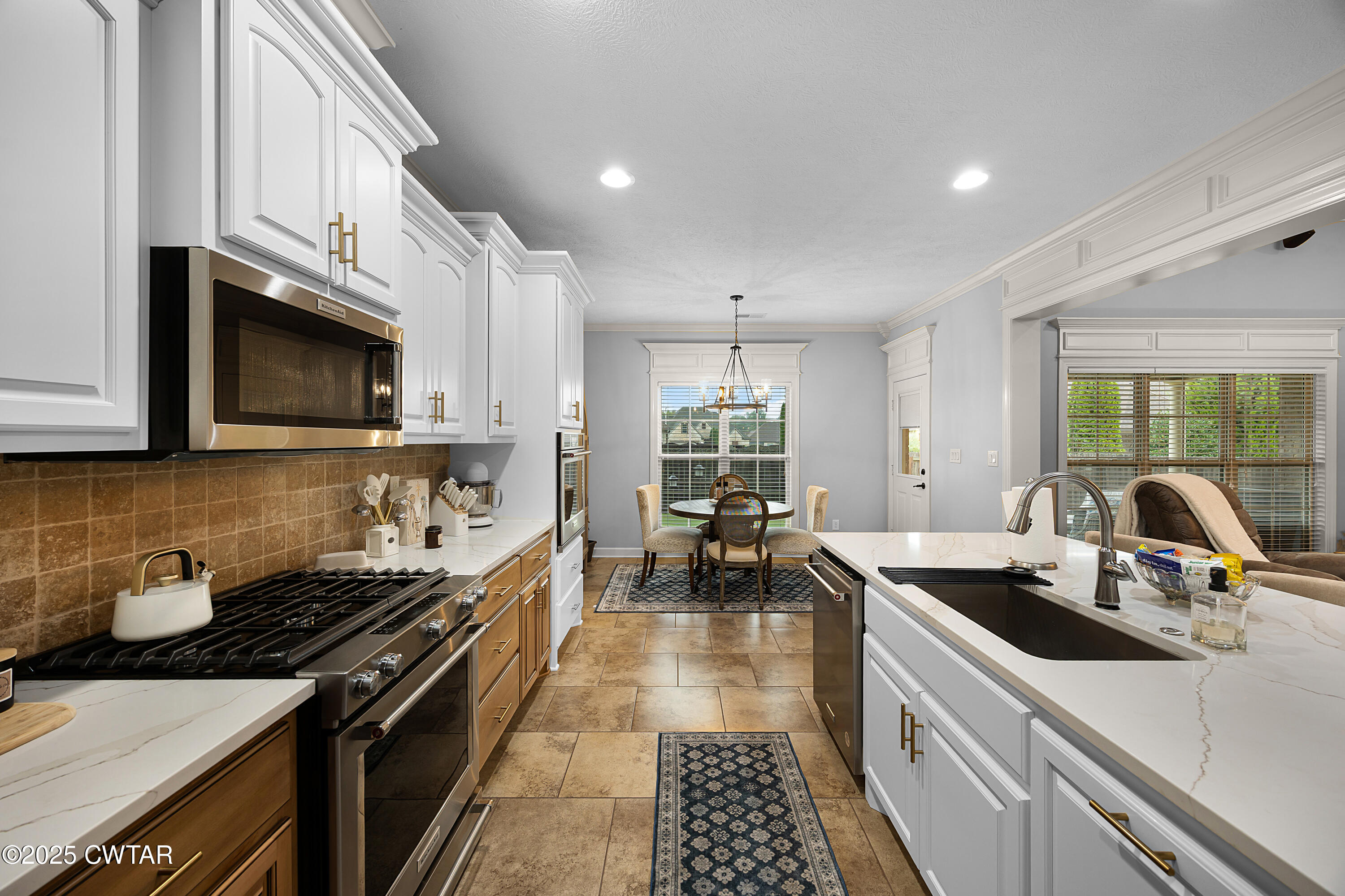 31 Perrington Cove Jackson, TN 38305 - Photo 13 of 27 a kitchen with lots of counter top space a sink a stove and a window