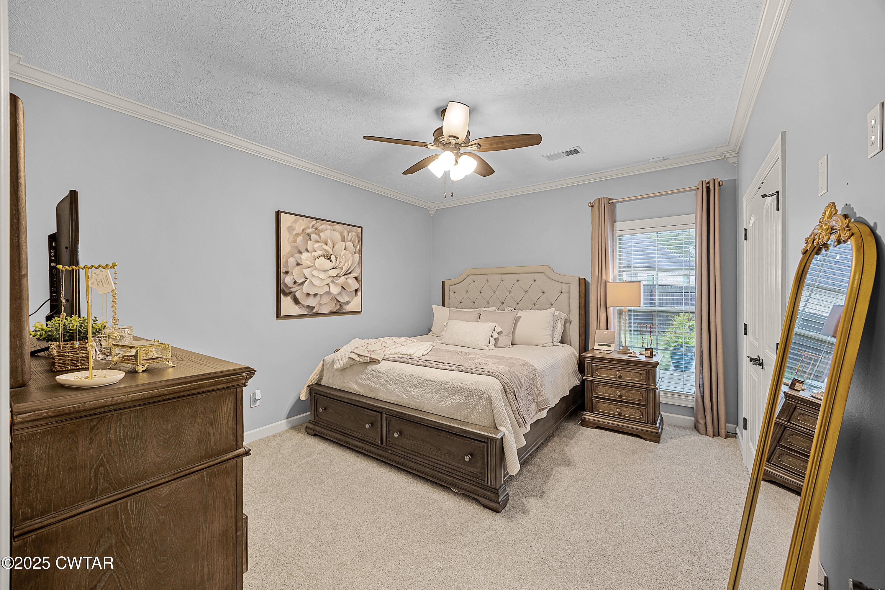 31 Perrington Cove Jackson, TN 38305 - Photo 16 of 27 a bedroom with a bed and a chandelier