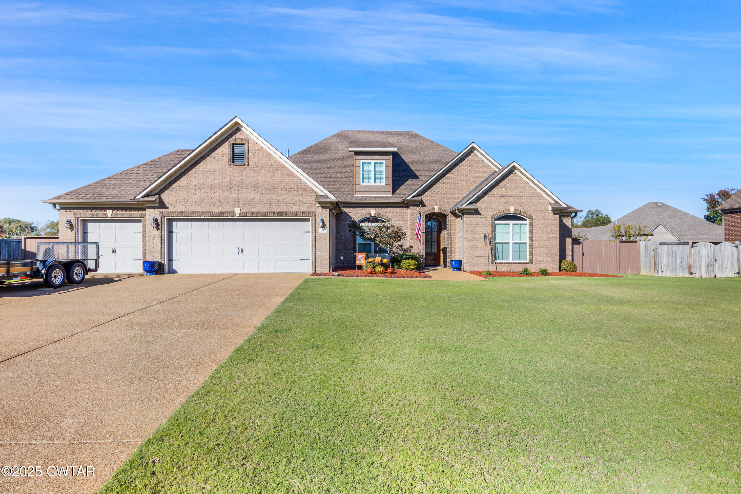 31 Perrington Cove Jackson, TN 38305 - Photo 2 of 27 a view of a big house with a big yard and large trees