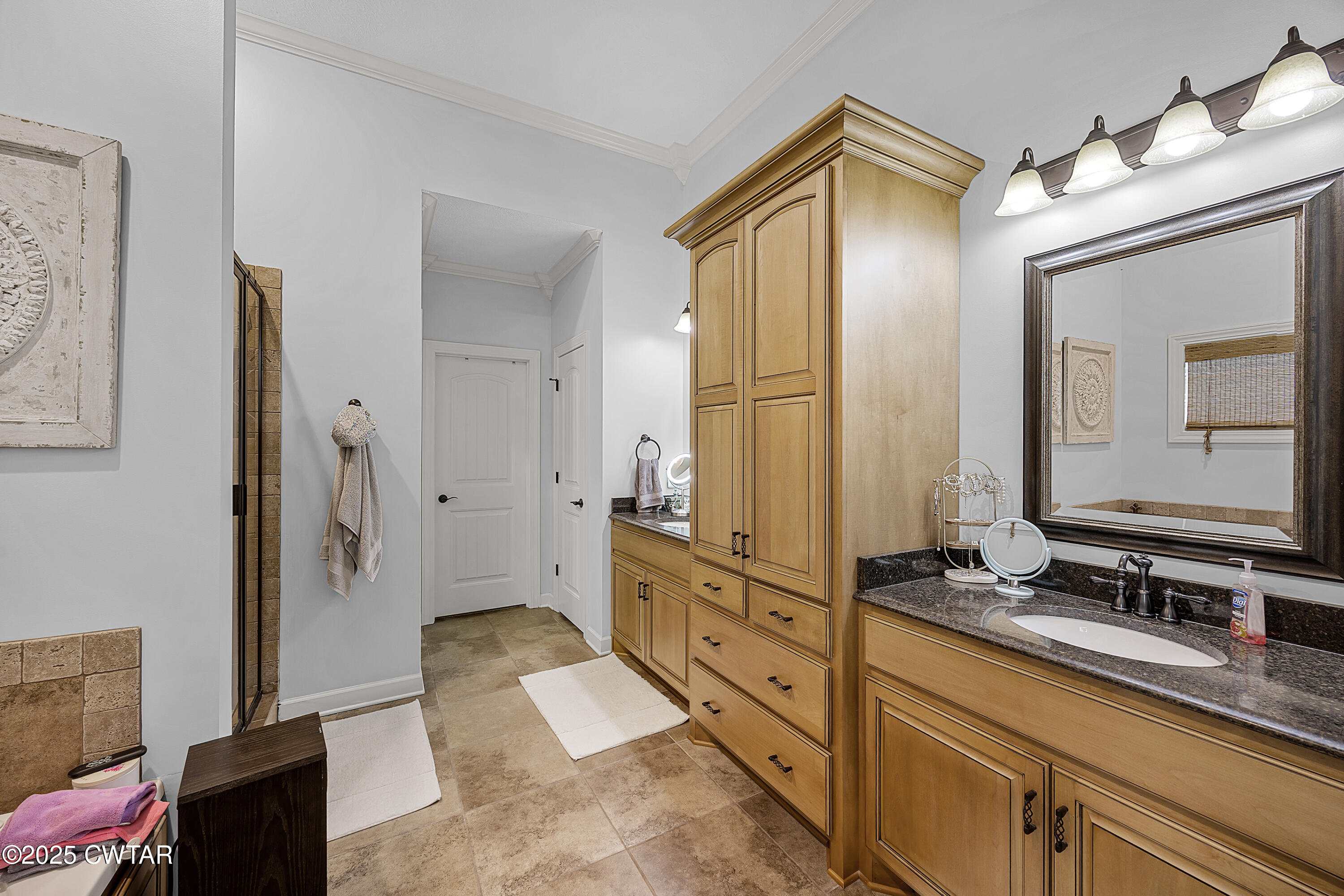 31 Perrington Cove Jackson, TN 38305 - Photo 22 of 27 a spacious bathroom with a double vanity sink a mirror and a shower