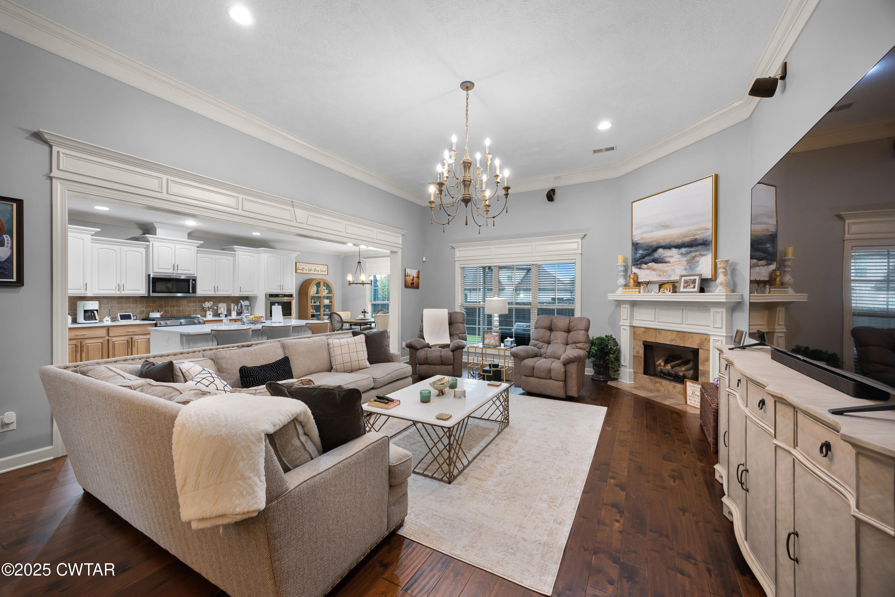 31 Perrington Cove Jackson, TN 38305 - Photo 3 of 27 a living room with furniture a fireplace and a flat screen tv