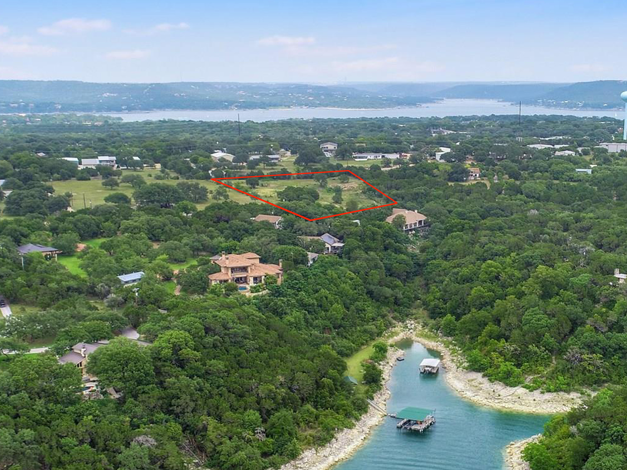 4715 Eck Lane Austin, TX 78734 - Photo 2 of 19 an aerial view of a city with lots of residential buildings and mountain view in back