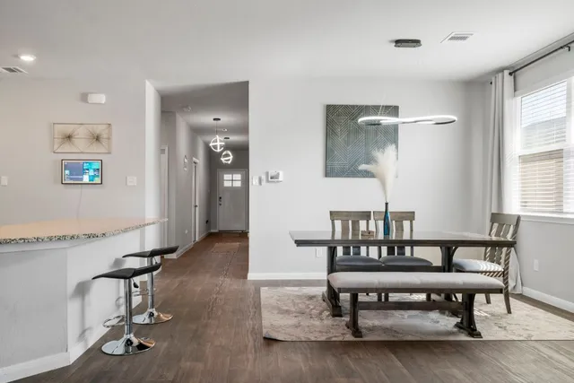a view of a room with a table and chairs