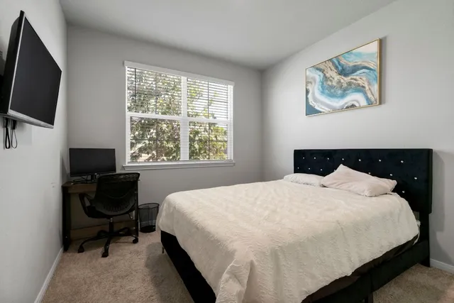 a bedroom with a bed and a window