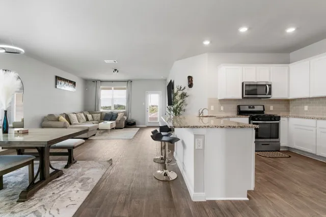 a kitchen with sink refrigerator and microwave