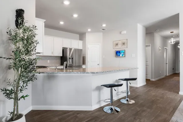 a kitchen with kitchen island stainless steel appliances a sink and cabinets