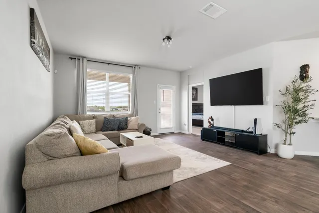 a living room with furniture and a flat screen tv