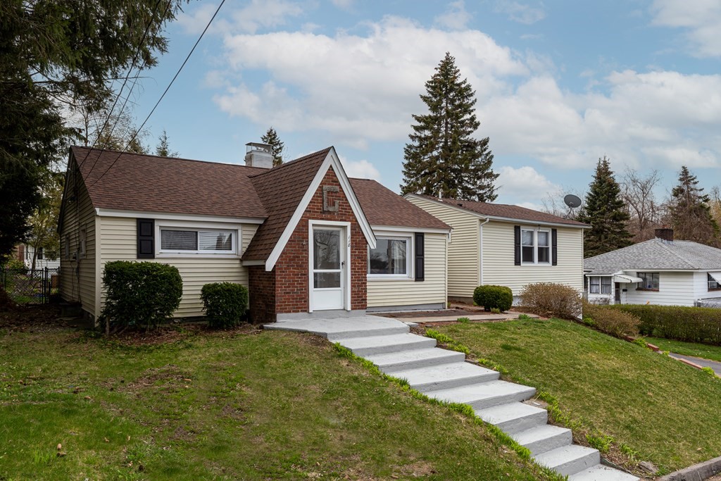 118 Wilkinson Street Worcester, MA 01606 - Photo 1 of 26 a front view of a house with a yard