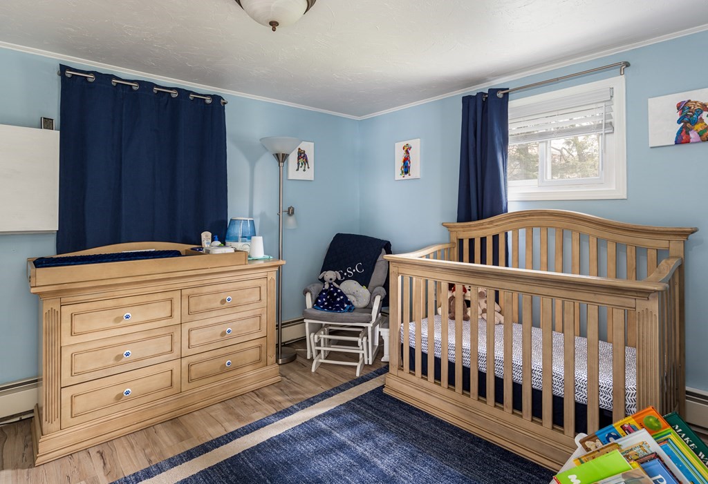 118 Wilkinson Street Worcester, MA 01606 - Photo 12 of 26 a bedroom with a bed and wooden floor