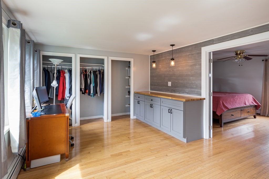 118 Wilkinson Street Worcester, MA 01606 - Photo 17 of 26 a hall with a cabinet and a large mirror