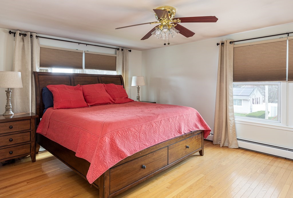 118 Wilkinson Street Worcester, MA 01606 - Photo 20 of 26 a bedroom with a bed chandelier and a window