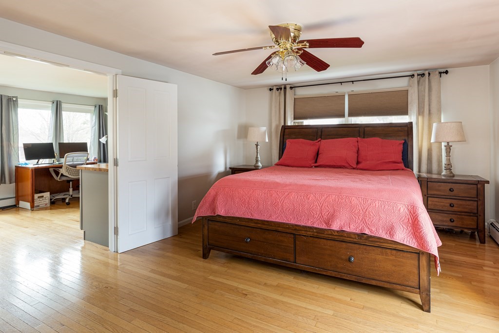118 Wilkinson Street Worcester, MA 01606 - Photo 21 of 26 a large bed sitting in a bedroom next to a window and a chandelier