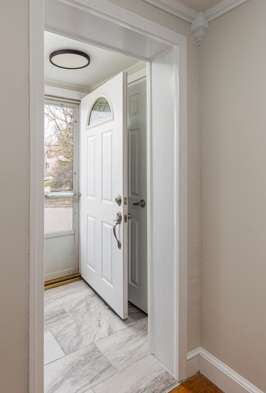 118 Wilkinson Street Worcester, MA 01606 - Photo 4 of 26 a view of a hallway with wooden floor and a livingroom