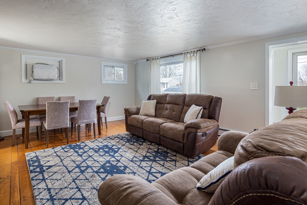 118 Wilkinson Street Worcester, MA 01606 - Photo 7 of 26 a living room with furniture a bed and a window