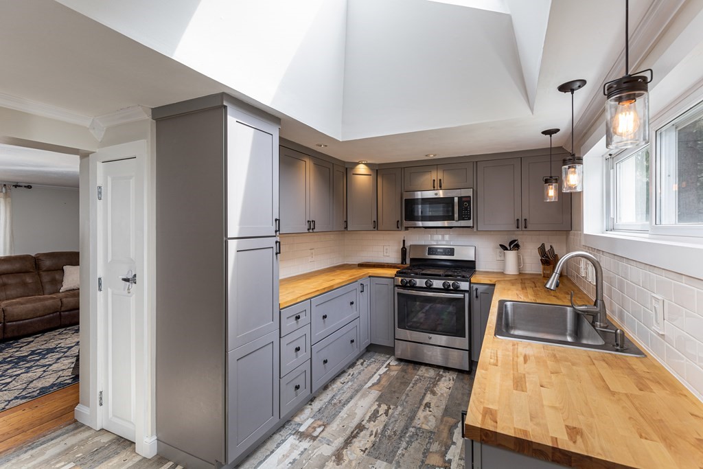 118 Wilkinson Street Worcester, MA 01606 - Photo 9 of 26 a kitchen with stainless steel appliances granite countertop a refrigerator stove and sink