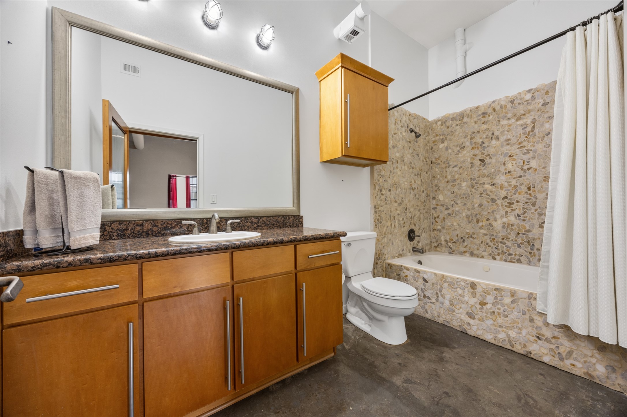 705 Main Street, Unit 513 Houston, TX 77002 - Photo 9 of 22 a bathroom with a toilet sink and mirror