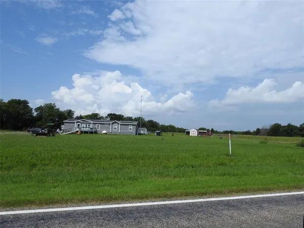 a view of a big yard with a lots of green space