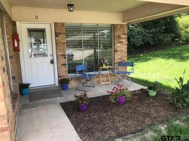 a view of a backyard with sitting area