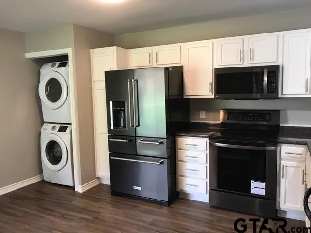 a kitchen with a refrigerator and a stove top oven