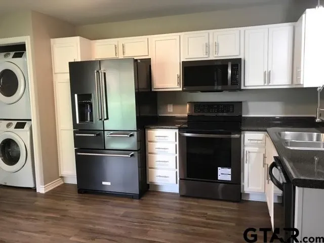 a kitchen with stainless steel appliances a stove microwave and a refrigerator