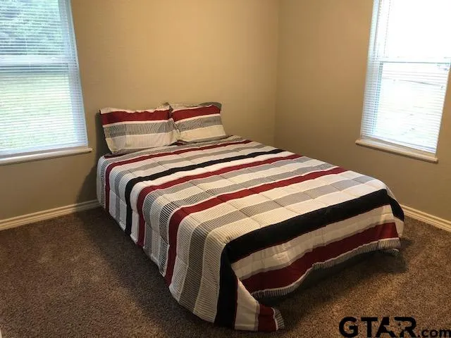 a bedroom with a bed and window