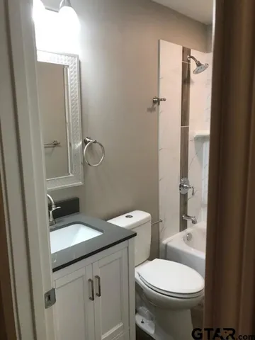 a bathroom with a bathtub and a toilet