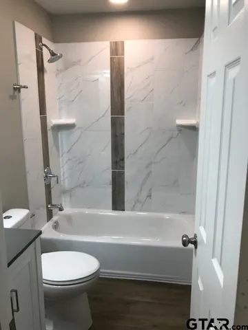 a street view with large trees